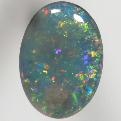 SOLID BLACK OPAL Sparkling reds, yellows over ocean blue